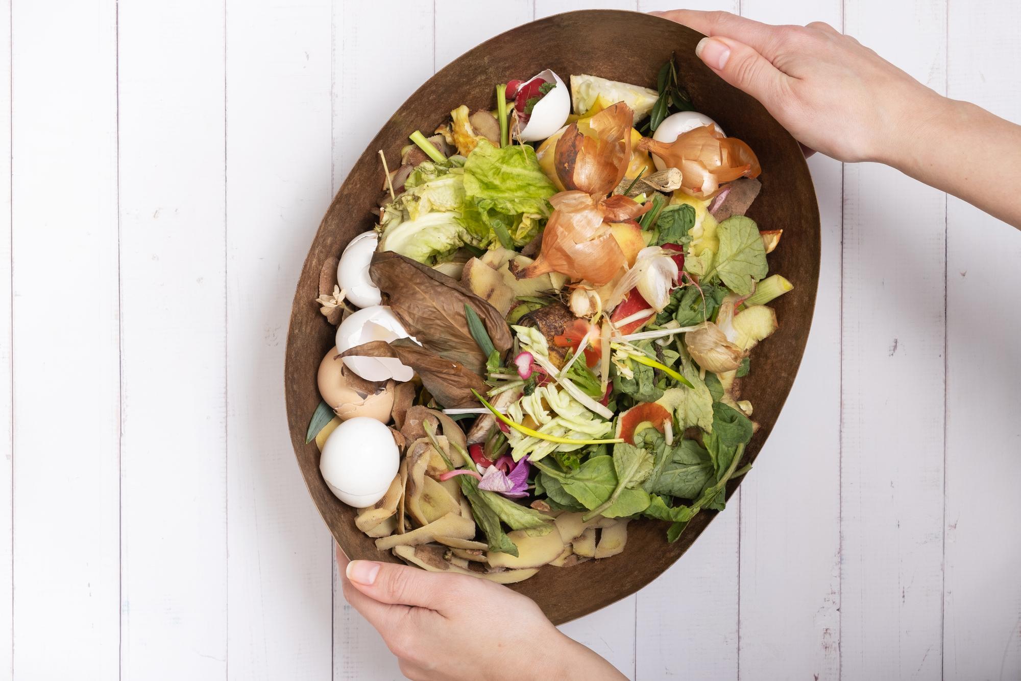 hands arranging salad with grains